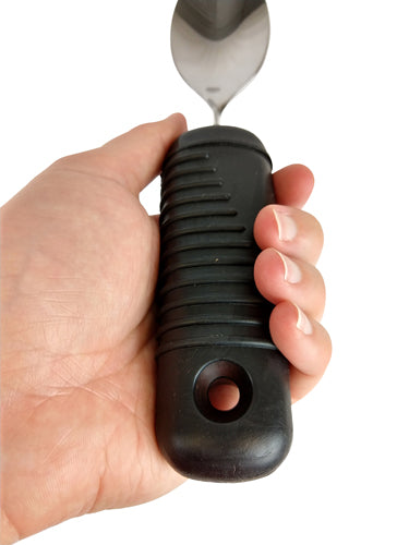 Hand holding a ribbed black handle spoon from Make Eating Easier Big Grip Utensil Set Blue Jay Brand for weak grip users.
