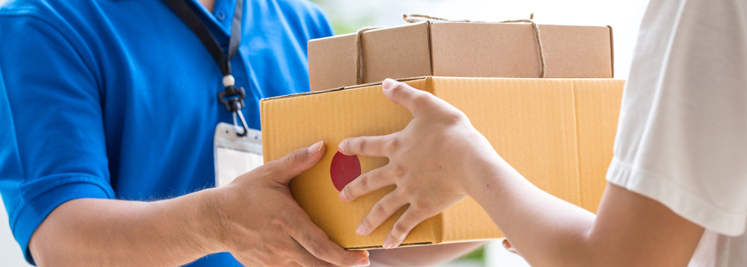 Image of a delivery person in a blue shirt holding a cardboard box to a person in a white shirt, with text overlay saying 'Free shipping Available On All Orders.