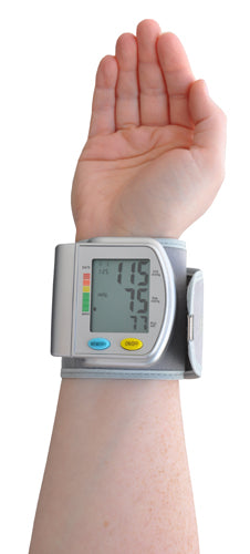 Wrist-mounted digital blood pressure monitor showing systolic, diastolic, and pulse readings on gray display panel