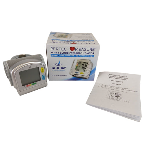Digital wrist blood pressure monitor with gray cuff, product box, and folded user manual on white background