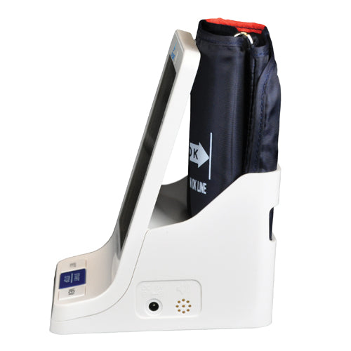 White digital blood pressure monitor with black cuff inserted and angled display panel on white background