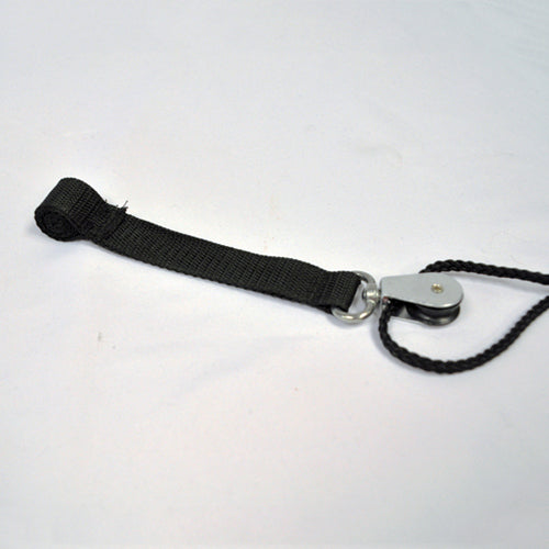 Small metal pulley attached to black braided rope and black fabric strap against white background