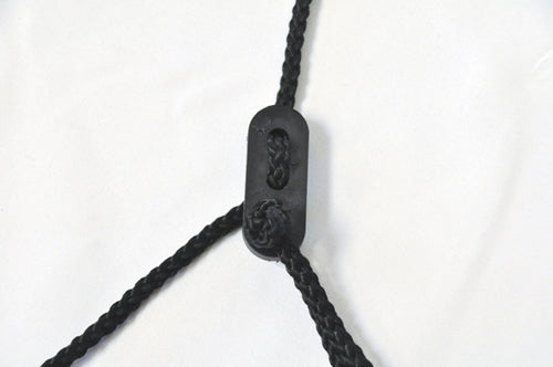 Black braided rope with knotted ends threaded through a small black rectangular plastic piece on white background