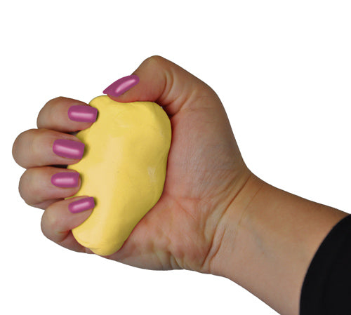 Hand with purple polished nails squeezing a yellow stress relief putty against a white background