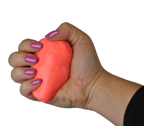 Hand with lavender nail polish squeezing a bright coral-colored stress relief putty on white background