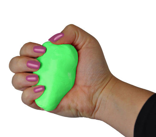 Hand with glossy mauve nails squeezing a bright lime green stress relief putty against white background