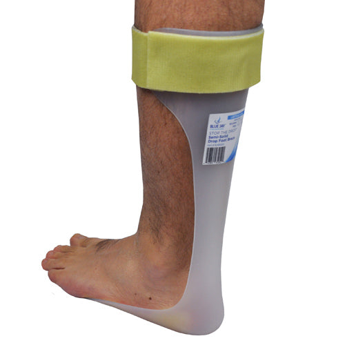 Translucent plastic lower leg drop foot brace with yellow padded cuff worn on right leg against white background