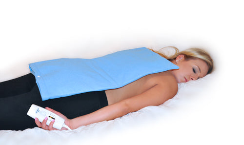 Heating Pad 12 x24 Moist/Dry 4 Position Switch Auto-Off applied to woman's back for pain relief and comfort.