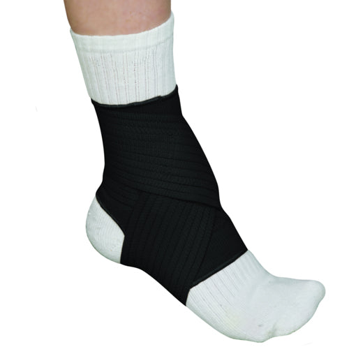 Black elastic ankle support wrap firmly securing ankle over white sock on a bare leg against white background