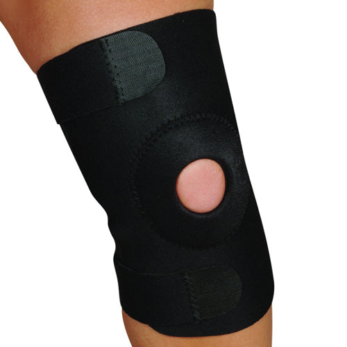 Black knee brace with open patella design and adjustable Velcro straps providing support on bare leg against white background