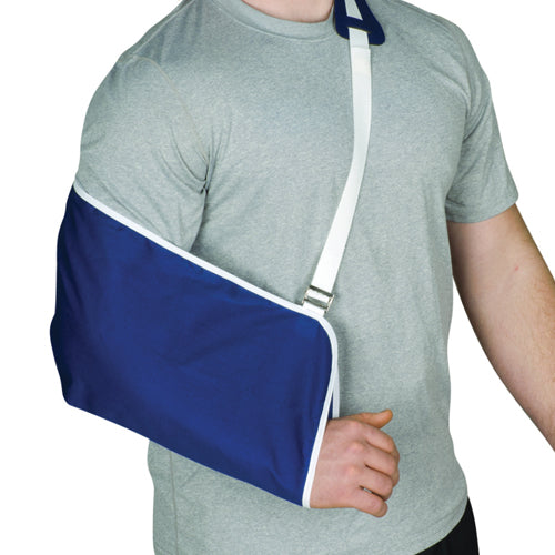 Navy blue arm sling with white trim and adjustable shoulder strap supporting arm against light gray shirt background