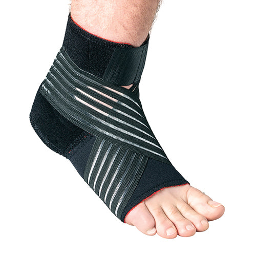 Foot wearing black ankle support wrap with adjustable elastic straps providing compression and stability on white background