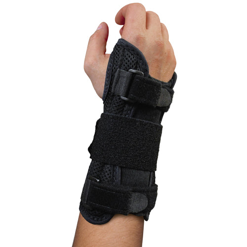 Hand secured in black breathable wrist brace with multiple adjustable hook-and-loop straps for firm support and immobilization
