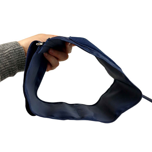 Hand holding a navy blue fabric strap with an adjustable section and attached cable against white background